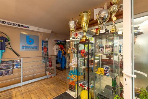 a room with a display case filled with trophies at BASELINE športový areál & penzión in Banská Bystrica