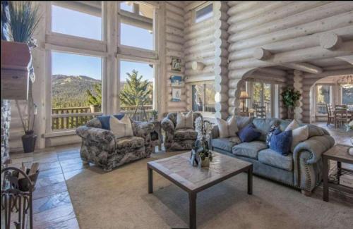 a living room with couches and a table at Hot Tub Game Room Large Deck w Incredible View Penticton Lodge by AvantStay in Big Bear Lake