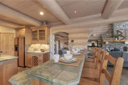 a kitchen with a table and chairs in a room at Hot Tub Game Room Large Deck w Incredible View Penticton Lodge by AvantStay in Big Bear Lake