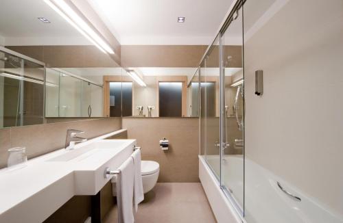 a bathroom with a sink and a toilet and a shower at Hotel Actual in Barcelona