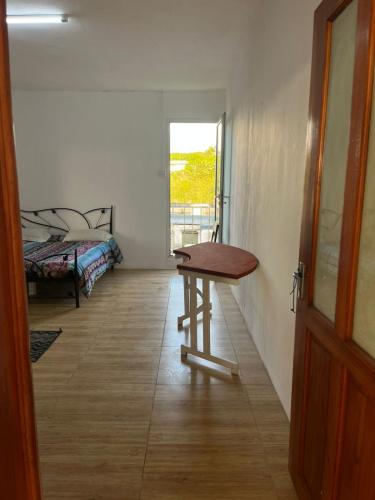 a room with a wooden table and a bed at Lavish 4 bedroom apartment in Curepipe