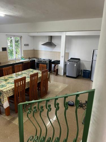 a kitchen and dining room with a table and chairs at Lavish 4 bedroom apartment in Curepipe