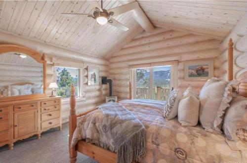 a bedroom with a bed and a wooden ceiling at Hot Tub Game Room Large Deck w Incredible View Penticton Lodge by AvantStay in Big Bear Lake