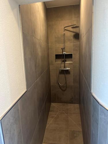 a shower with a shower head in a bathroom at Hotel Seeadler in Friedrichshafen