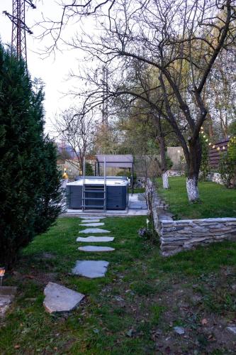 a garden with a gazebo in a park at Bob’house in Vulcan
