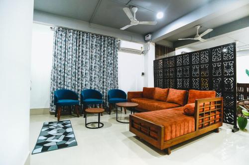 a living room with a couch and chairs at Nivasa Homestay - Khanapara Guwahati in Guwahati