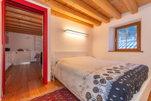 a bedroom with a bed with a red frame at Appartamento Tre Valli 5 in Alleghe