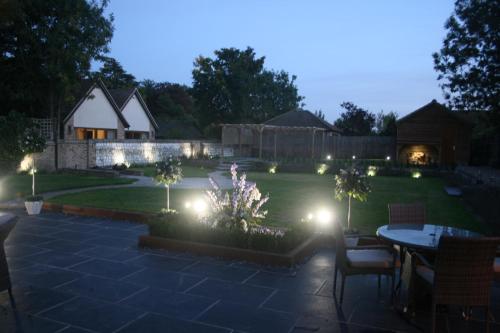 a garden at night with lights on the grass at Appletree Cottages in Mildenhall