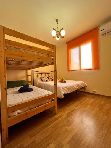 two bunk beds in a room with wooden floors at El Chalete in Otura