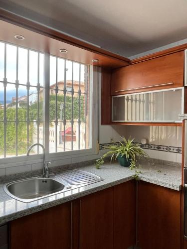 a kitchen with a sink and a window at El Chalete in Otura