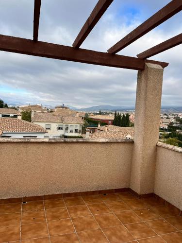 a balcony with a view of a city at El Chalete in Otura