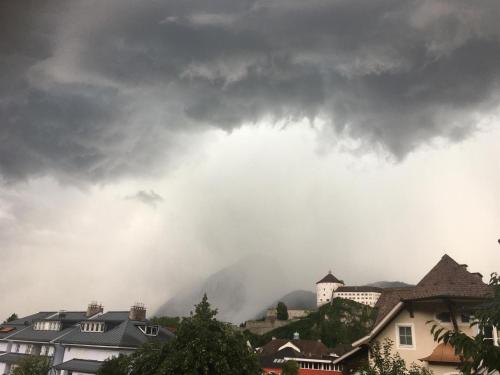 a storm cloud over a city with houses and buildings at Villa Gartenblick in Kufstein