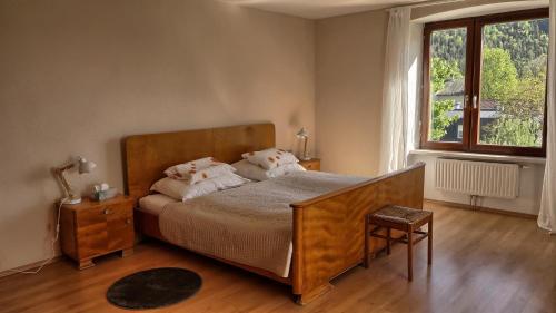 a bedroom with a bed and a large window at Villa Gartenblick in Kufstein