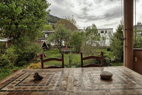 a patio with two chairs and a view of a yard at Villa Gartenblick in Kufstein