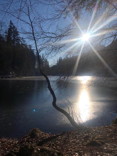 a view of a lake with the sun in the sky at Villa Gartenblick in Kufstein