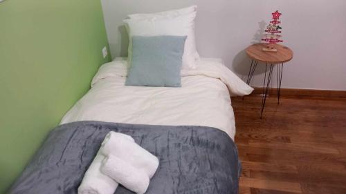 a bedroom with a bed with white sheets and pillows at V for Vacation in Ioannina