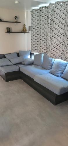 - un canapé dans le salon avec des oreillers bleus dans l'établissement le lac des rêves camping 4 étoiles, à Lattes