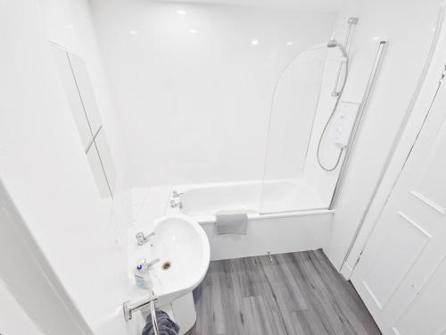 a white bathroom with a sink and a mirror at Edinburgh Backpackers - over 18s only in Edinburgh