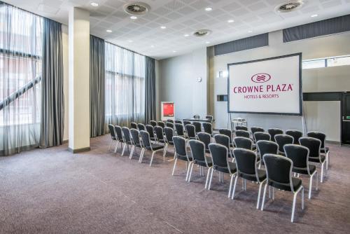 a room with rows of chairs and a screen at Crowne Plaza Manchester City Centre by IHG in Manchester