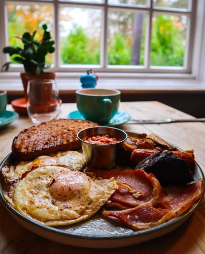 a plate of breakfast food with eggs bacon and corn at Fritton Lake - The Clubhouse in Great Yarmouth