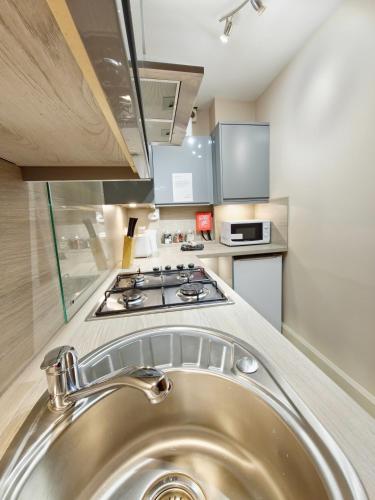 a kitchen with a sink and a stove at Edinburgh Backpackers - over 18s only in Edinburgh