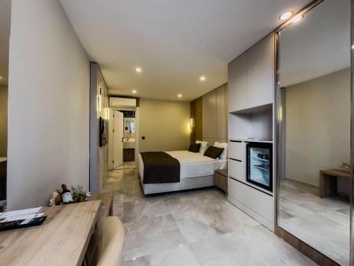 a hotel room with a bed and a kitchen at Quality Gold Suite Hotel in Antalya