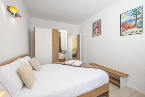 a bedroom with a white bed in a room at Monaco Border - Bel appartement rénové - CM in Beausoleil