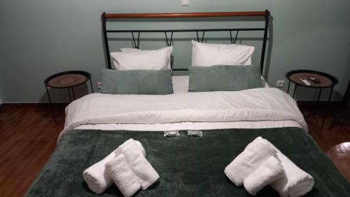a bedroom with a bed with towels on it at V for Vacation in Ioannina