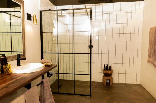 a bathroom with a shower and a sink at Last Word Madikwe in Madikwe Game Reserve