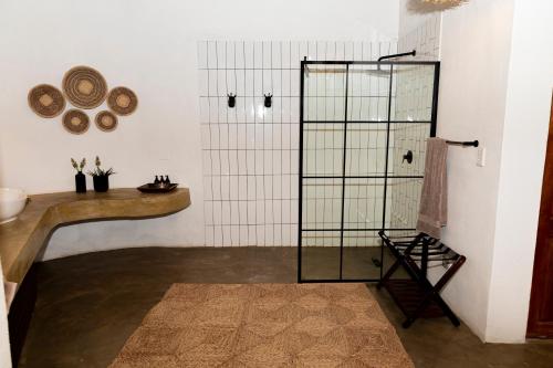 a bathroom with a shower with a counter and a sink at Last Word Madikwe in Madikwe Game Reserve