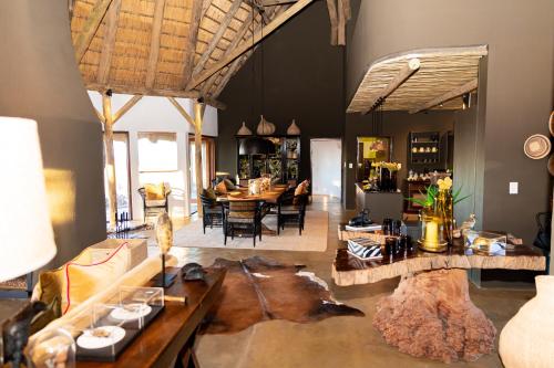 a living room with a couch and a table at Last Word Madikwe in Madikwe Game Reserve