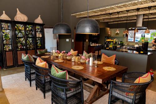 a dining room with a wooden table and chairs at Last Word Madikwe in Madikwe Game Reserve