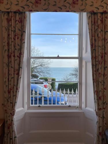 a window with a view of the ocean at The Osborne Apartments in Torquay