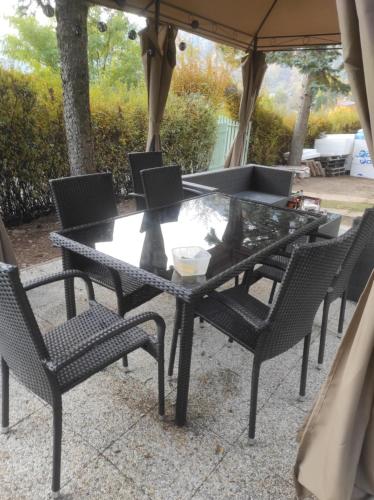 a black table and chairs under an umbrella at Villa Evetes in Jablonov nad Turnou