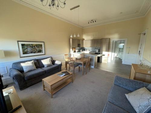 a living room with a couch and a table at The Osborne Apartments in Torquay