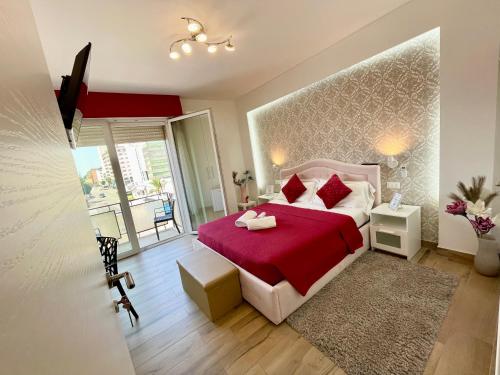 a bedroom with a red bed with a red blanket at ARBI VENICE STATiON in Mestre
