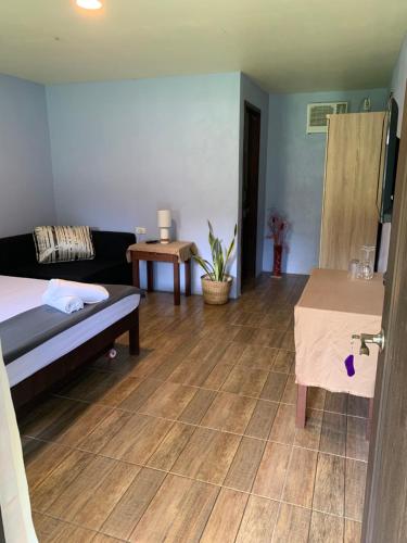 a living room with a bed and a table at Onur Inn in El Nido
