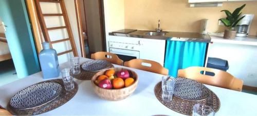 a kitchen with a table with baskets of fruit on it at Chalet 3 étoiles - eeiid0 in Matour