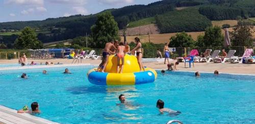 a group of people in a swimming pool at Chalet 3 étoiles - eeiid0 in Matour
