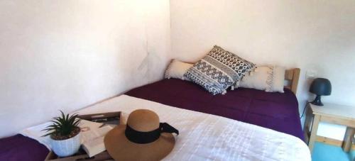 a bedroom with a bed with a hat on it at Chalet 3 étoiles - eeiid0 in Matour