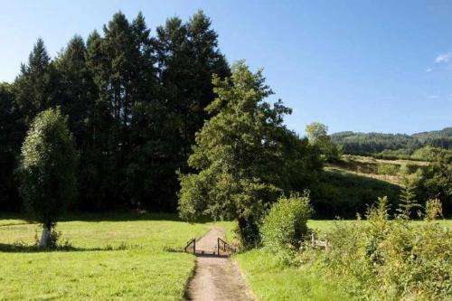 a small barn in a field with a dirt road at Chalet 3 étoiles - eeiid0 in Matour