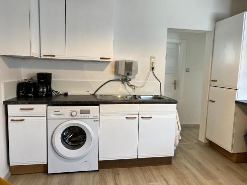 a kitchen with a washing machine and a sink at FirmenQuartier24 Zülpich DG in Zülpich