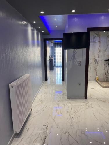 a lobby with a marble floor and a elevator at MONASTHRIOY PALLAS 3 By MAKHOME in Thessaloniki