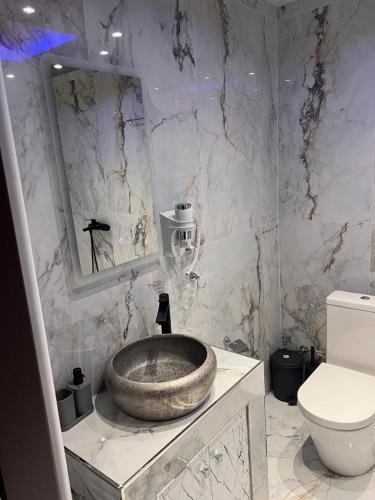 a bathroom with a sink and a toilet and a mirror at MONASTHRIOY PALLAS 3 By MAKHOME in Thessaloniki