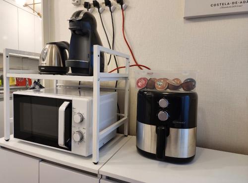 a kitchen with a microwave and a coffee maker at Lucy Stay in Seoul