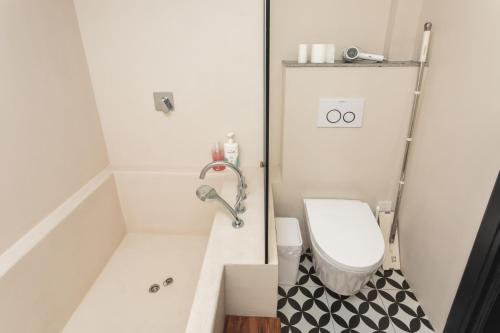 a small bathroom with a tub and a toilet at Tonight Homestay West Nanjing Road Shanghai in Shanghai