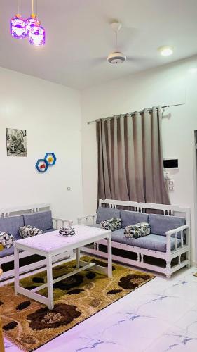 a living room with a couch and a table at Star - private apartments in Luxor