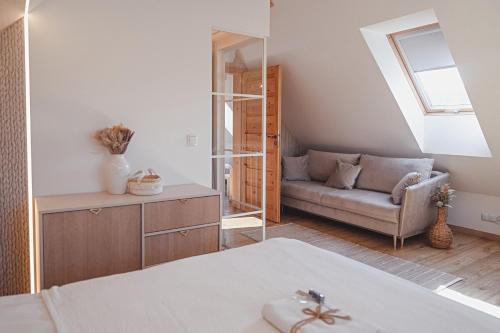 a room with a bed and a couch at Tarninowe Wzgórze in Kunkowa
