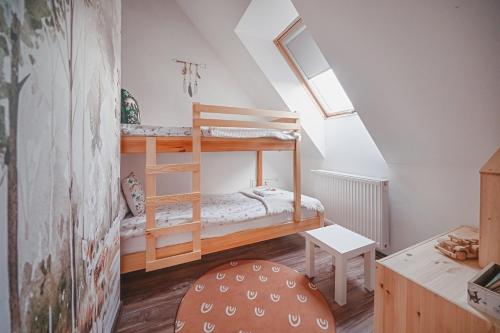 a room with two bunk beds in a attic at Tarninowe Wzgórze in Kunkowa