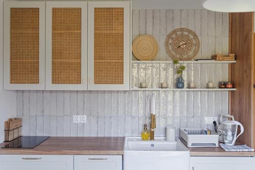a kitchen with white cabinets and a counter top at Tarninowe Wzgórze in Kunkowa